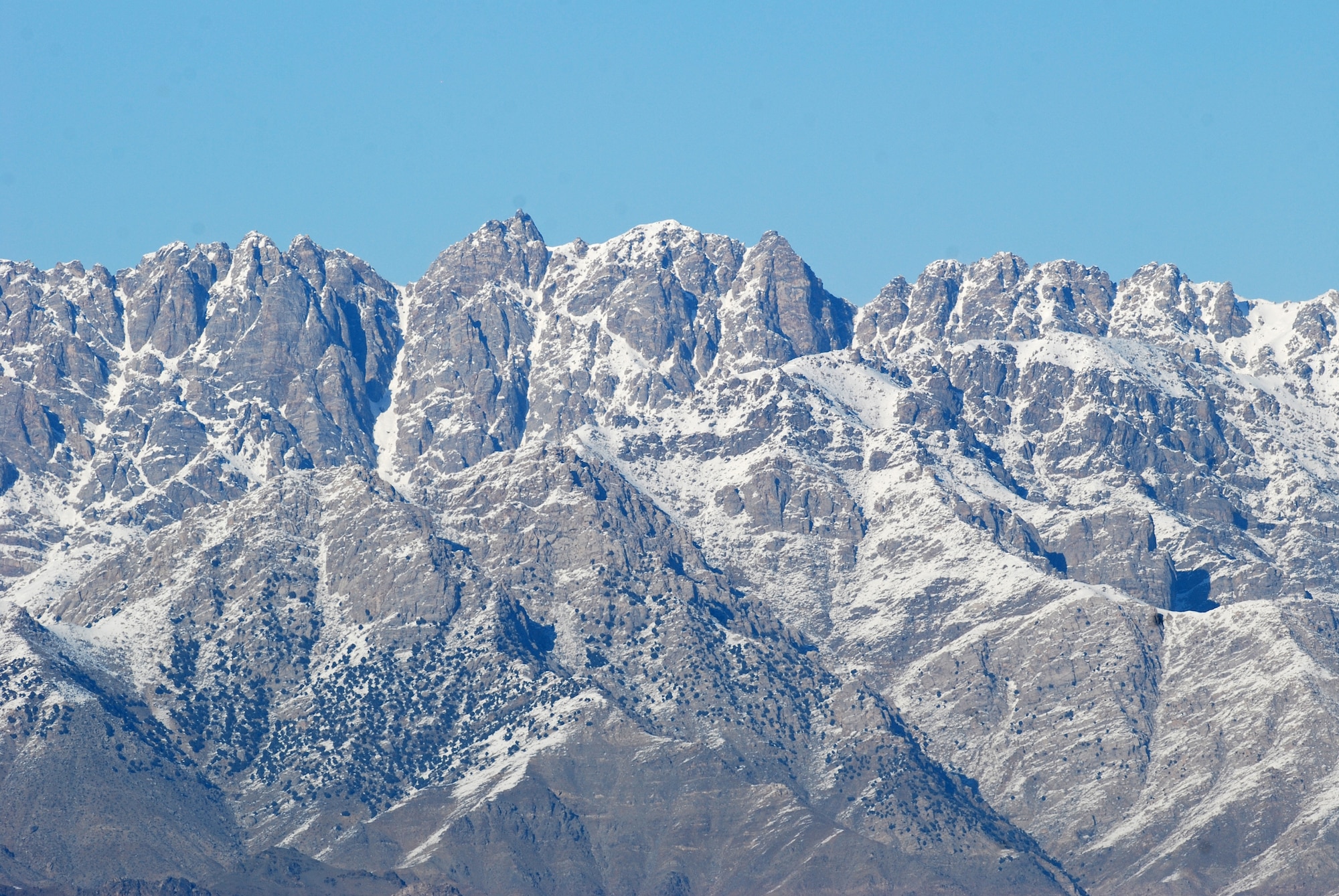 A rugged mountain range surrounds Bagram Airfield on three sides, including this mountain on the north end of the runway. There were strong winds at Bagram Airfield the morning of Feb. 15, 2014, which enabled the normal haze in the valley to clear. (U.S. Air Force photo by Capt. Brian Wagner/Released)