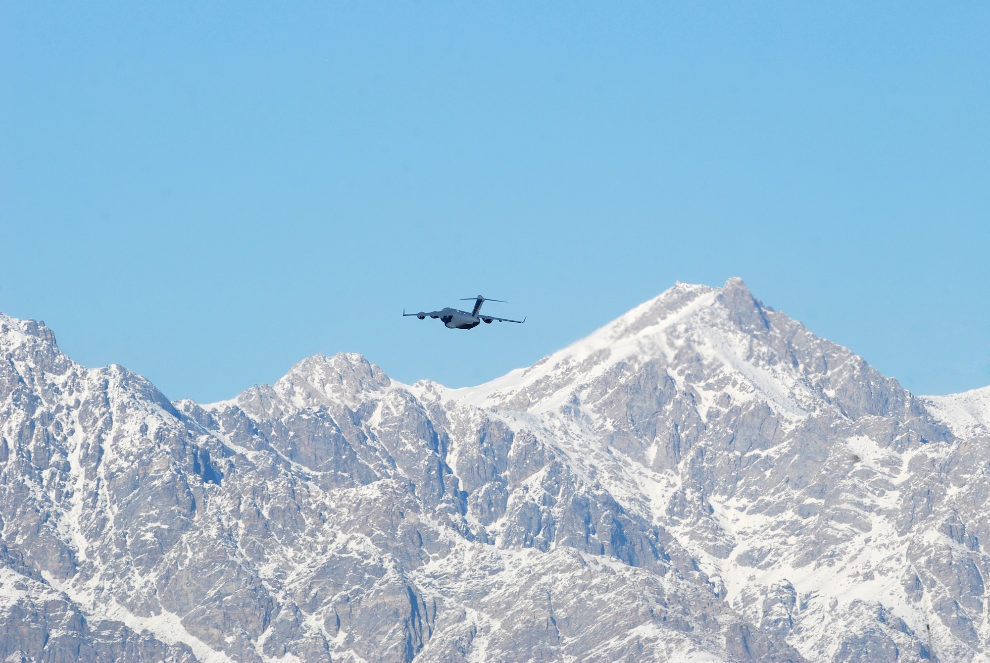 A C-17 Globemaster III clears a mountain following a takeoff from Bagram Airfield, Afghanistan, Feb. 15, 2014. Aircraft departing Bagram often have to climb over the rugged mountains that surround the area on three sides. (U.S. Air Force photo by Capt. Brian Wagner/Released)