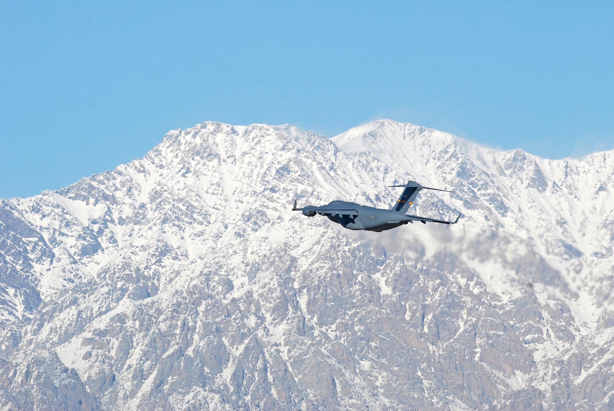 A C-17 Globemaster III takes off from Bagram Airfield, Afghanistan, Feb. 15, 2014. There were strong winds at Bagram Airfield in the morning, which enabled the normal haze in the valley to clear. (U.S. Air Force photo by Capt. Brian Wagner/Released)