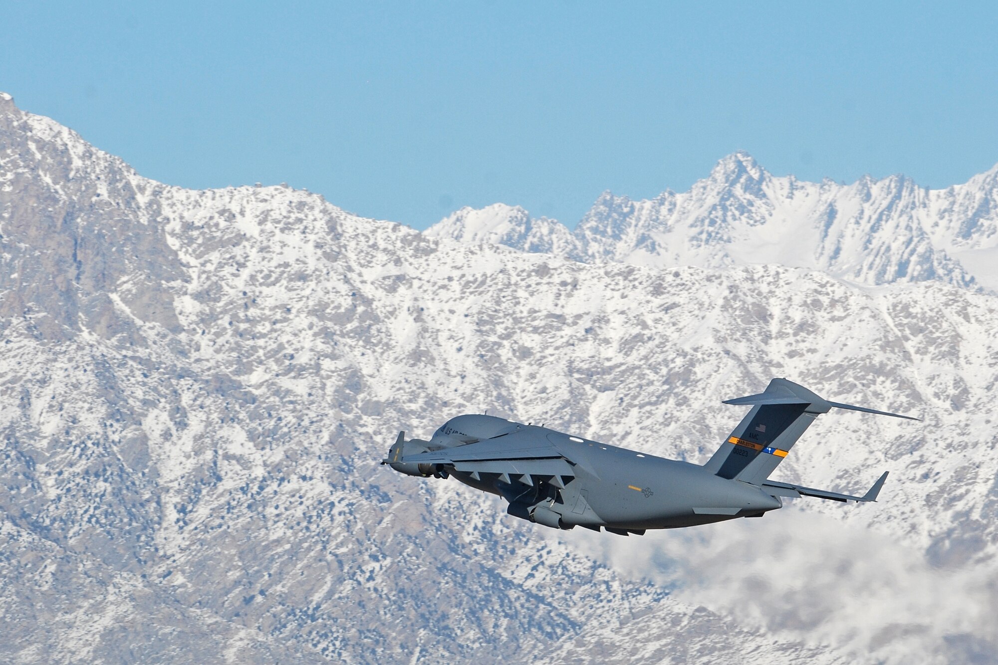 A C-17 Globemaster III takes off from Bagram Airfield, Afghanistan, Feb. 15, 2014. Aircraft departing Bagram often have to climb over the rugged mountains that surround the area on three sides. (U.S. Air Force photo by Capt. Brian Wagner/Released)