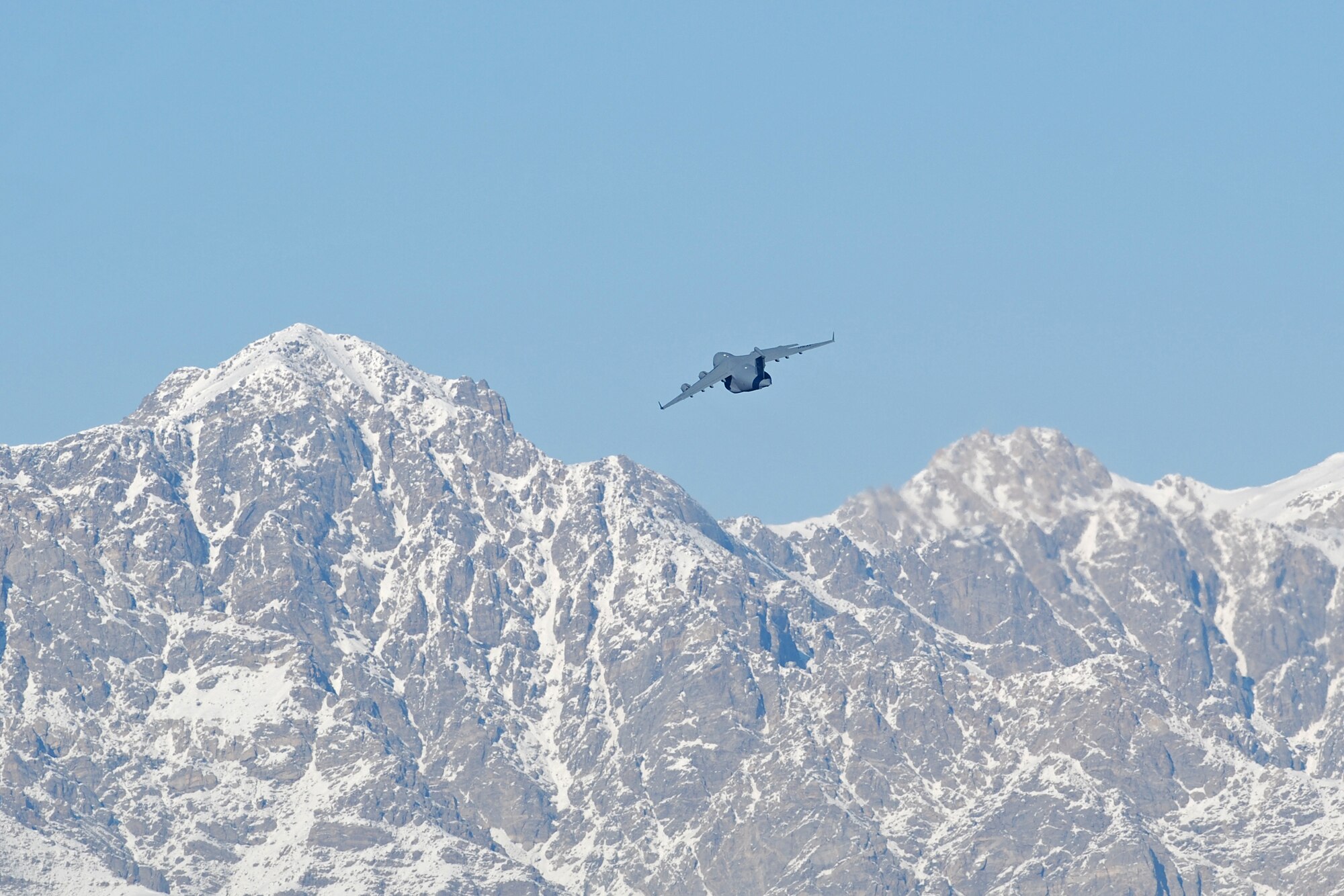 A C-17 Globemaster III clears a mountain following a takeoff from Bagram Airfield, Afghanistan, Feb. 15, 2014. Aircraft departing Bagram often have to climb over the rugged mountains that surround the area on three sides. (U.S. Air Force photo by Capt. Brian Wagner/Released)
