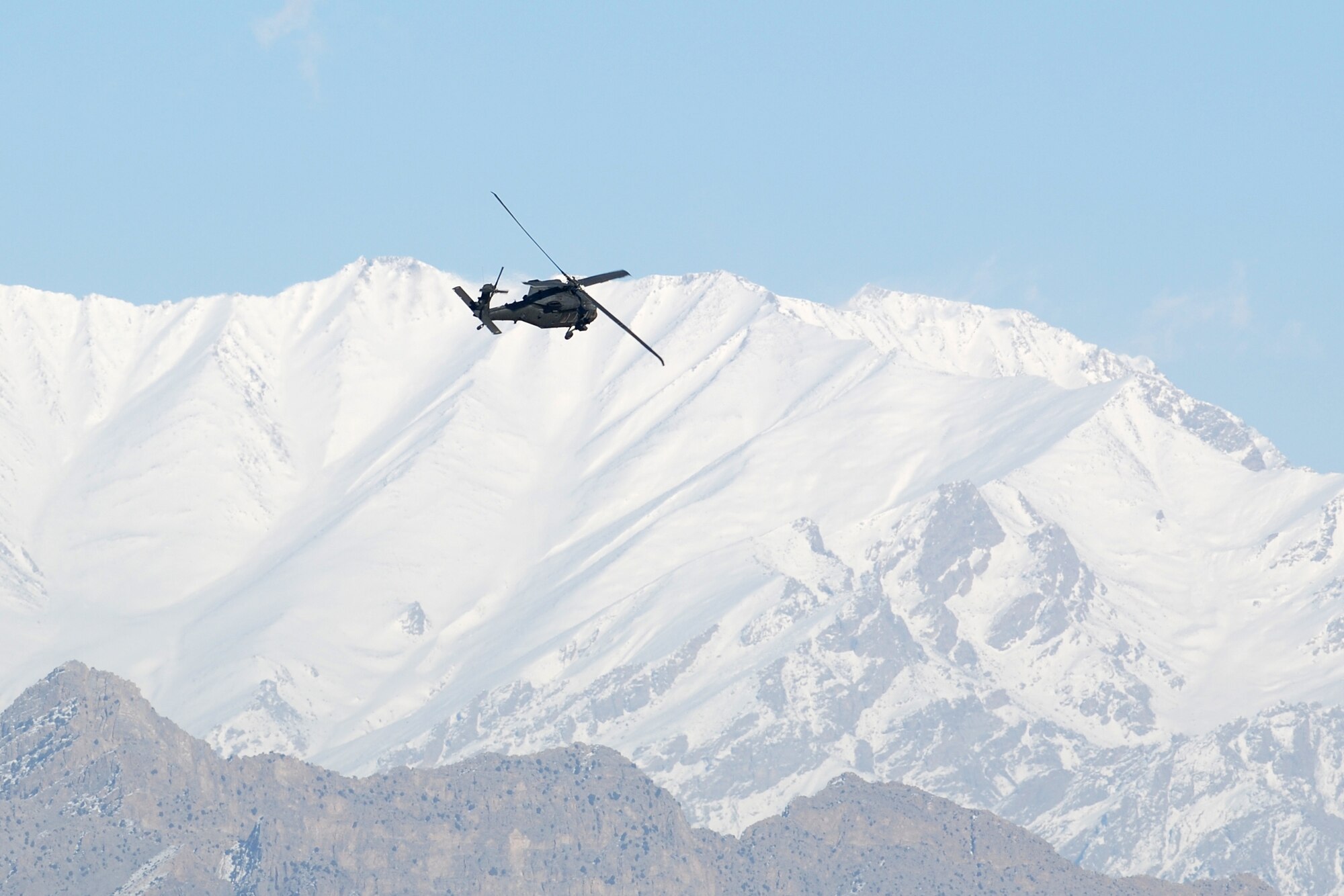 An Army UH-60 Black Hawk departs from Bagram Airfield, Afghanistan, Feb. 15, 2014. Aircraft departing Bagram often have to climb over the rugged mountains that surround the area on three sides. (U.S. Air Force photo by Capt. Brian Wagner/Released)
