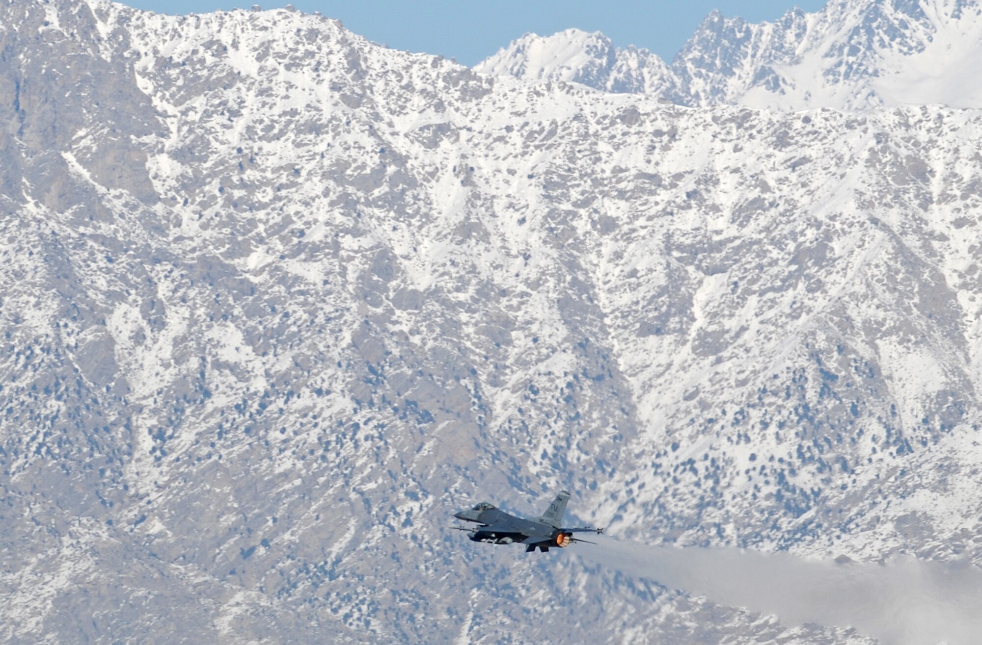 A F-16 Fighting Falcon takes off from Bagram Airfield, Afghanistan, Feb. 15, 2014. Aircraft departing Bagram often have to climb over the rugged mountains that surround the area on three sides. (U.S. Air Force photo by Capt. Brian Wagner/Released)