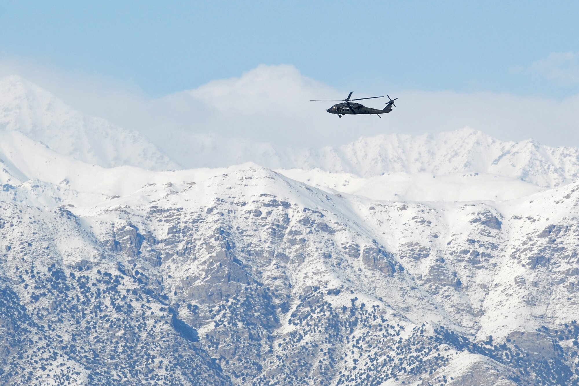 An Army UH-60 Black Hawk departs from Bagram Airfield, Afghanistan, Feb. 15, 2014. Aircraft departing Bagram often have to climb over the rugged mountains that surround the area on three sides. (U.S. Air Force photo by Capt. Brian Wagner/Released)