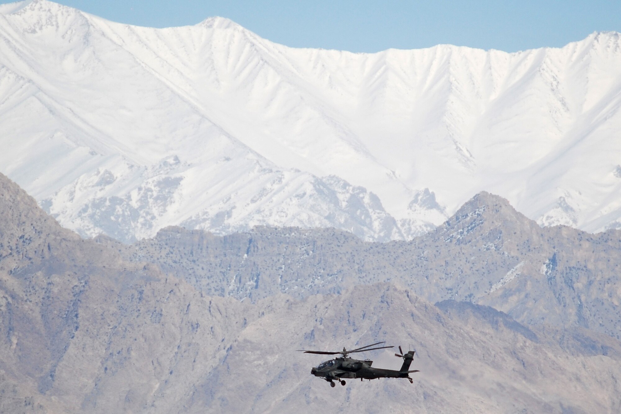 An AH-64 Apache departs from Bagram Airfield, Afghanistan, Feb. 15, 2014. Strong winds allowed a clear sky during the morning. (U.S. Air Force photo by Capt. Brian Wagner/Released)