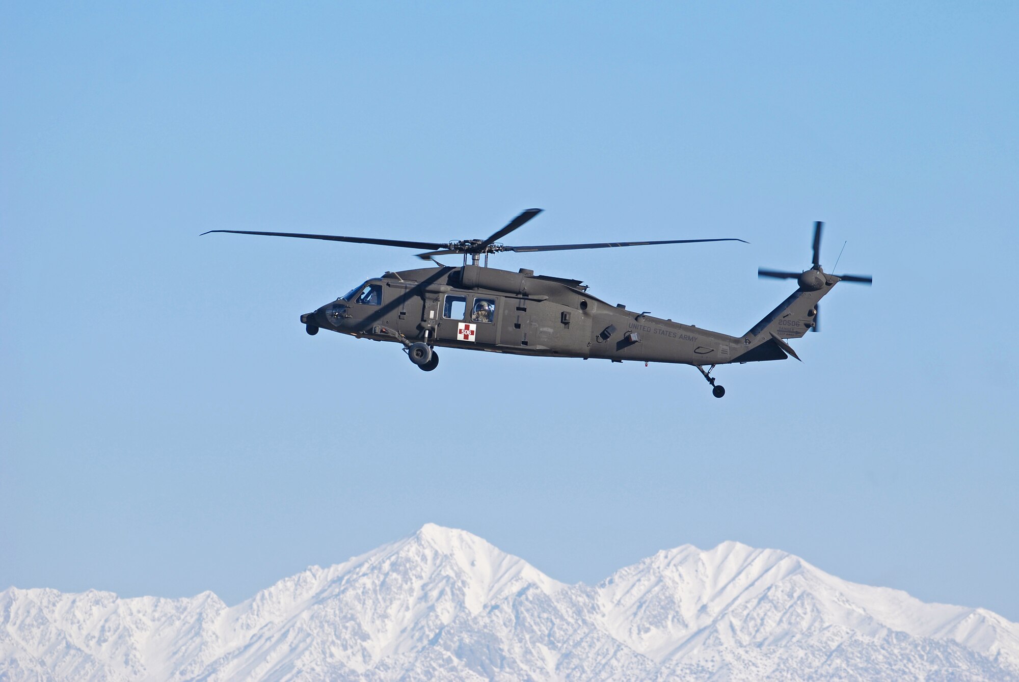 An Army UH-60 Black Hawk MEDEVAC helicopter arrives at Bagram Airfield, Afghanistan, Feb. 15, 2014. There were strong winds at Bagram Airfield in the morning, which enabled the normal haze in the valley to clear. (U.S. Air Force photo by Capt. Brian Wagner/Released)