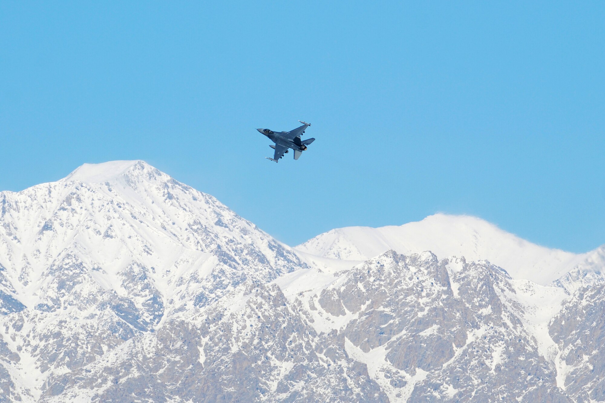 A F-16 Fighting Falcon takes off from Bagram Airfield, Afghanistan, Feb. 15, 2014. Aircraft departing Bagram often have to climb over the rugged mountains that surround the area on three sides. (U.S. Air Force photo by Capt. Brian Wagner/Released)