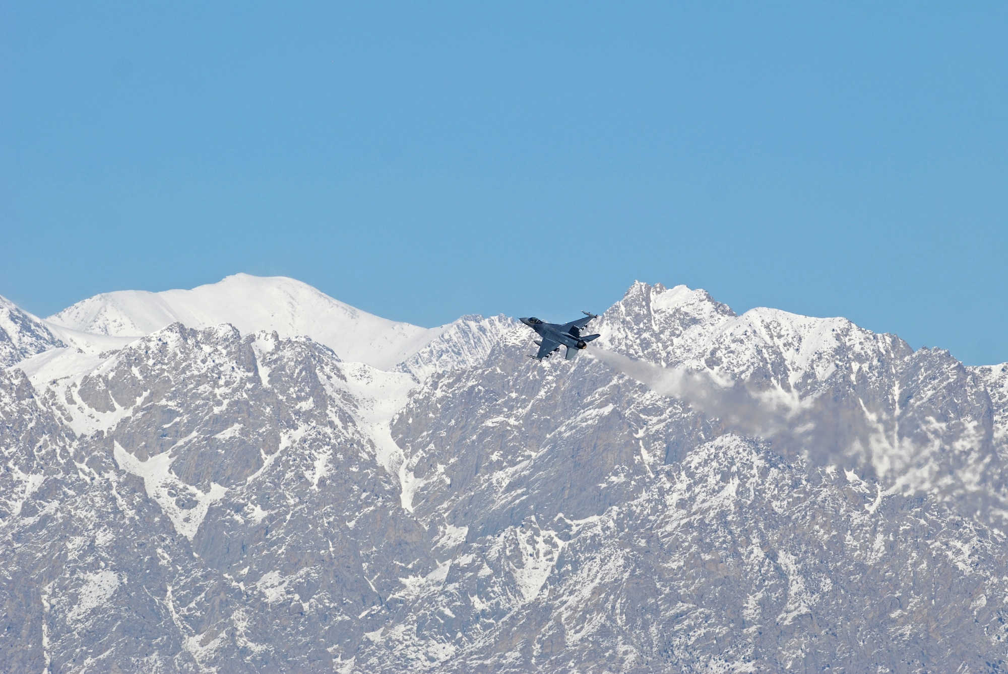 A F-16 Fighting Falcon takes off from Bagram Airfield, Afghanistan, Feb. 15, 2014. Aircraft departing Bagram often have to climb over the rugged mountains that surround the area on three sides. (U.S. Air Force photo by Capt. Brian Wagner/Released)