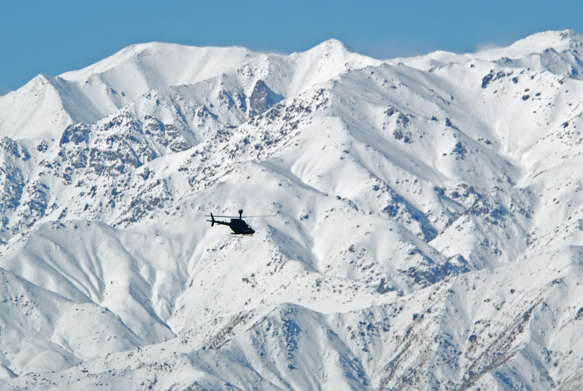 An Army OH-58D Kiowa Warrior departs Bagram Airfield, Afghanistan, Feb. 15, 2014. Strong winds allowed a clear sky during the morning. (U.S. Air Force photo by Capt. Brian Wagner/Released)