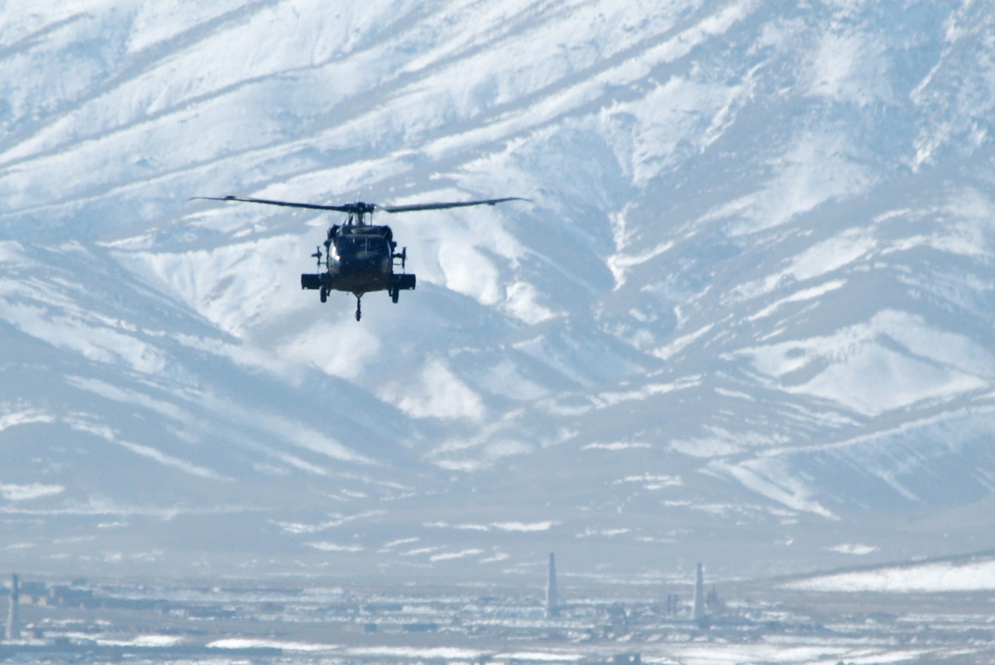 An Army UH-60 Black Hawk prepares to land at Bagram Airfield, Afghanistan, Feb. 15, 2014. Strong winds allowed the normal haze around Bagram to lift. (U.S. Air Force photo by Capt. Brian Wagner/Released)
