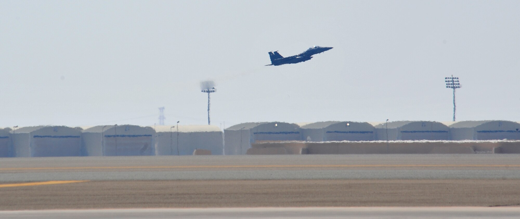 An F-15E fighter aircraft assigned to the 335th Expeditionary Fighter Squadron takes off to defend the base during an exercise in Southwest Asia, Feb. 14, 2014.  (U.S. Air Force photo by Staff Sgt. Michael Means/Released)