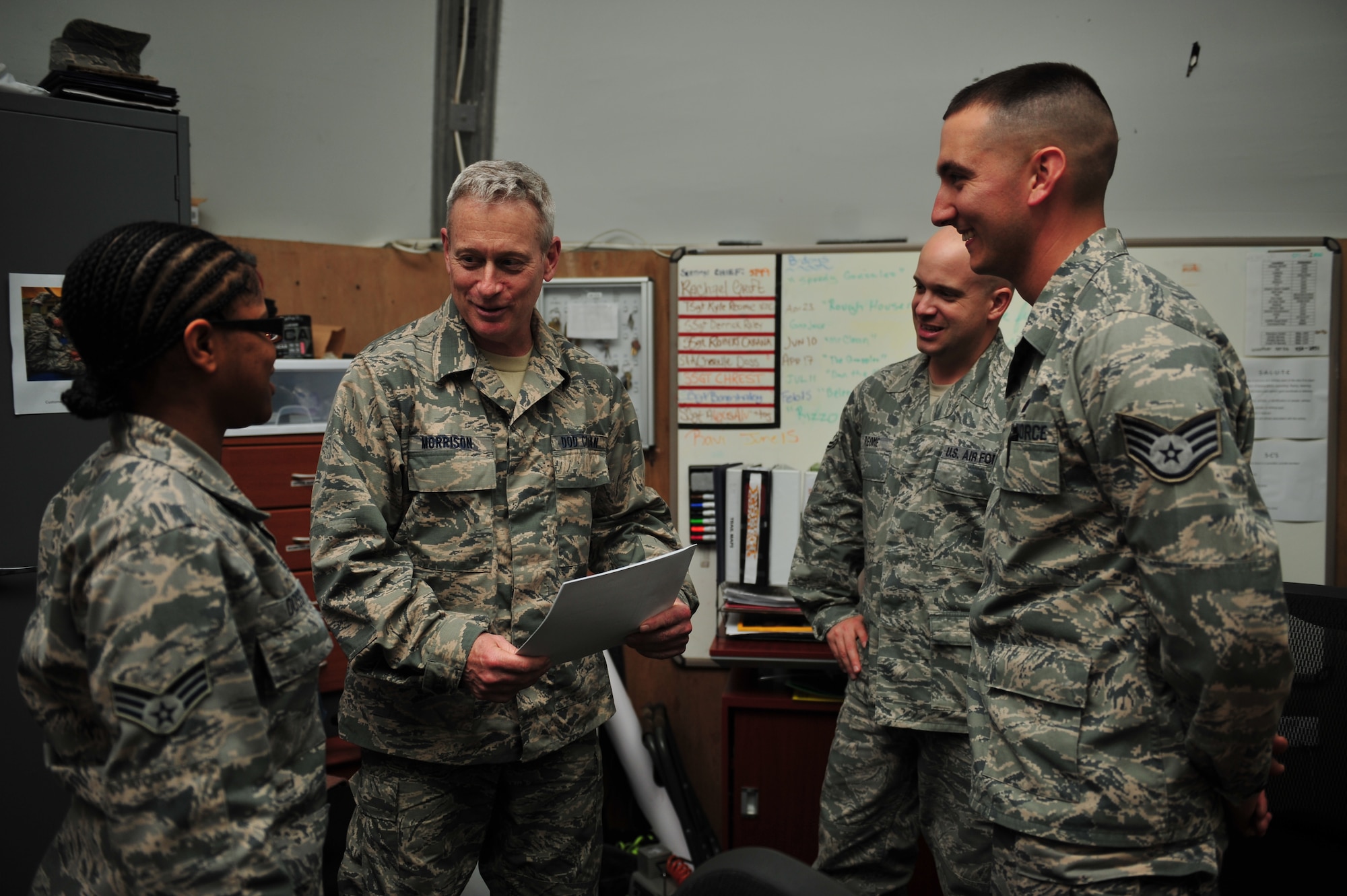 Bruce Morrison, 380th Expeditionary Force Support Squadron deputy commander, speaks with fitness center staff here, Feb. 12, 2014. Morrison served nearly 23 years as an enlisted Tactical Air Control Party specialist and 14 years as an Air Force civilian. He is a native of Boston and is deployed from Aviano Air Base, Italy. (U.S. Air Force photo by Staff Sgt. Michael Means)