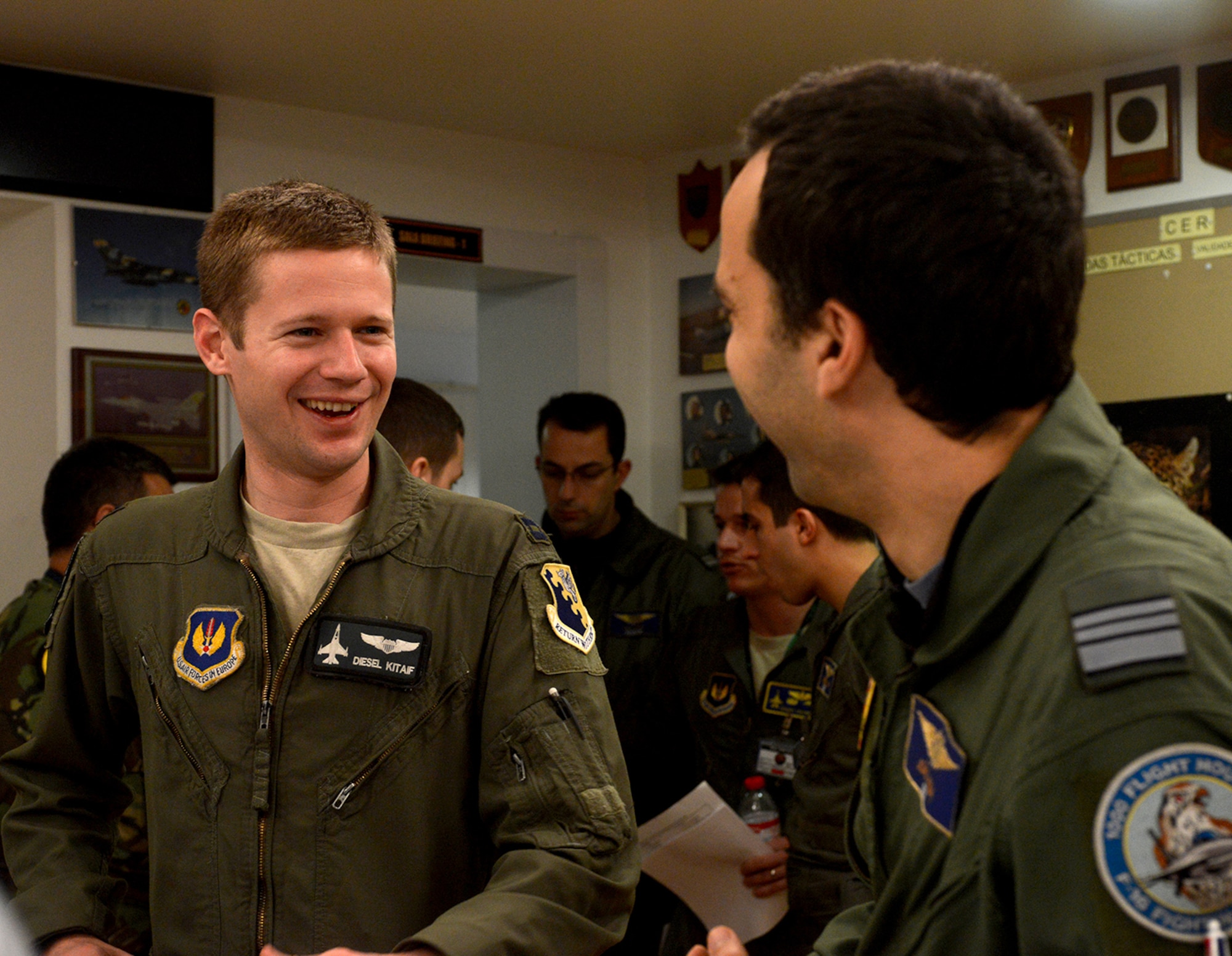 Lt. Col. Joao Rosa, right, and Capt. Eric Kitaif swap stories following a Feb. 12, 2014 large force exercise mission brief at the 301st Fighter Squadron. Approximately 260 personnel from the 31st Fighter Wing arrived in Monte Real Air Base, Portugal, in support of REAL THAW 14--a two-week close air support exercise hosted by the Portuguese Air Force. (U.S. Air Force photo/2nd Lt. Allie Delury)
