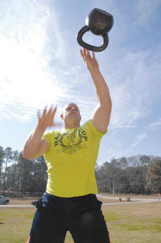 Staff Sgt. Charles Trimble works on his single arm alternating kettle bell swings during Marine Corps Systems Command’s strength and endurance circuit training here, Feb. 7.