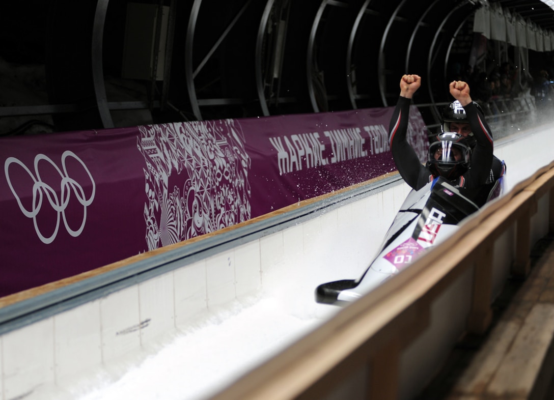 Former U.S. Army World Class Athlete Program bobsled driver Steven Holcomb of Park City, Utah, raises his fists in celebration of his Olympic bronze medal performance with Steven Langton of Melrose, Mass., aboard USA-1 in the two-man bobsled event Feb. 17 at Sanki Sliding Centre in Krasnaya Polyana, Russia. (U.S. Army photo by Tim Hipps, IMCOM Public Affairs.)