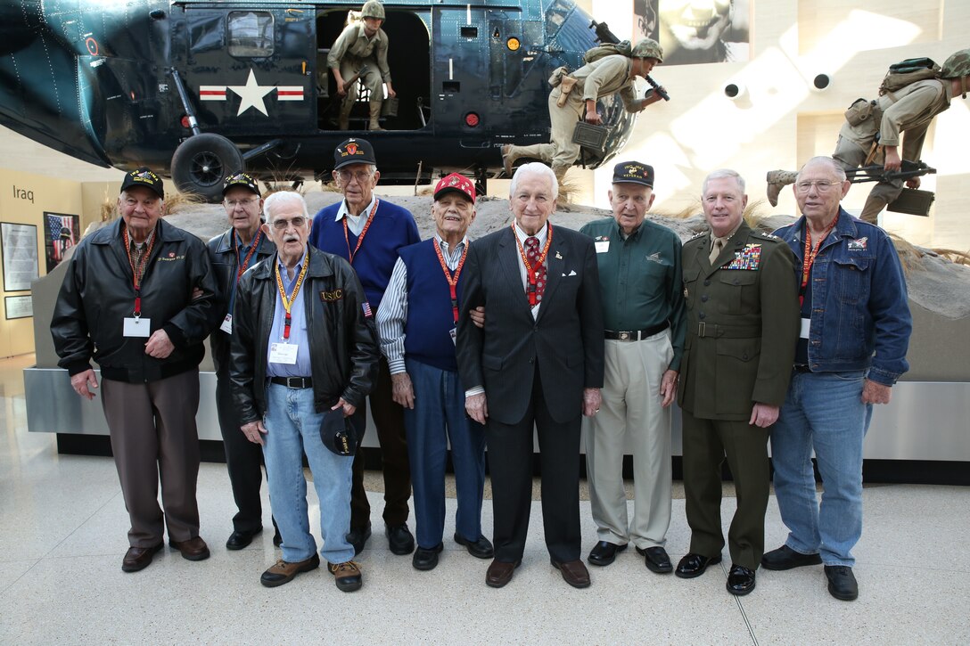 Eight Iwo Jima veterans pose for a photo with Lt. Gen. Kenneth Glueck, the deputy commandant of Combat Development and Integration and Commanding General of Marine Corps Combat Development Command, at an Iwo Jima commemoration at the National Marine Corps of the Museum on Feb. 14, 2014. The veterans attended the commemoration in honor of the 69th anniversary of the Battle of Iwo Jima.