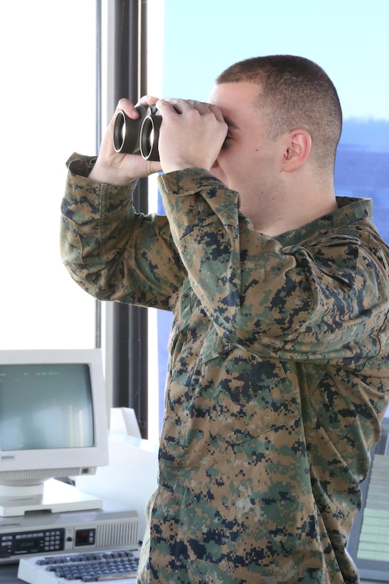 Cpl. Robert Smith stands in the Marine Corps Air Facility control tower on Feb. 11, 2014. Smith’s quick thinking and training helped avoid a hazard and potentially save millions of dollars’ worth of equipment.  