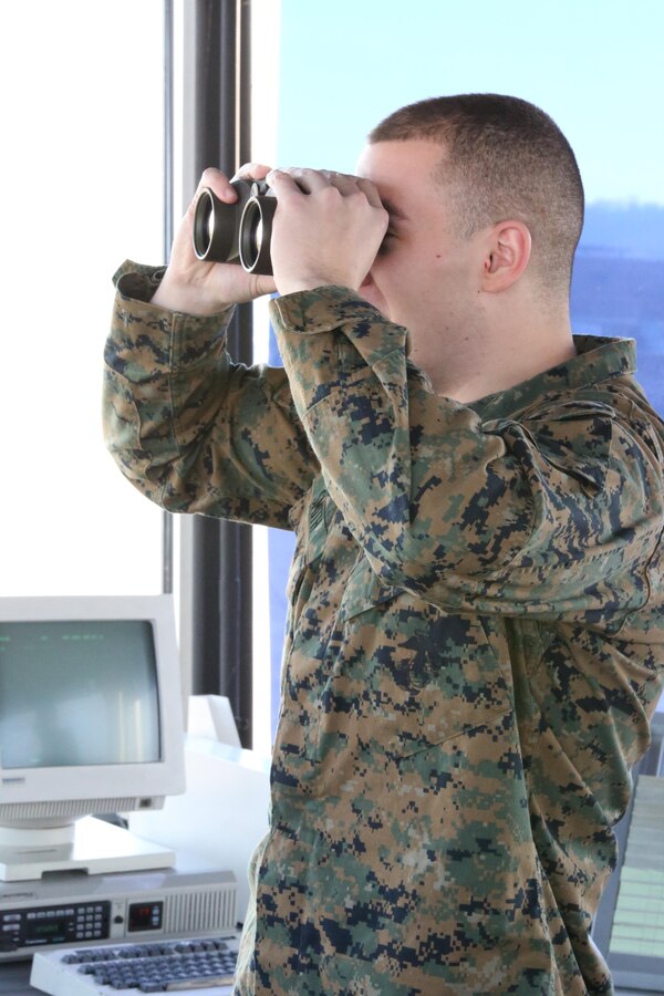 Cpl. Robert Smith stands in the Marine Corps Air Facility control tower on Feb. 11, 2014. Smith’s quick thinking and training helped avoid a hazard and potentially save millions of dollars’ worth of equipment.  