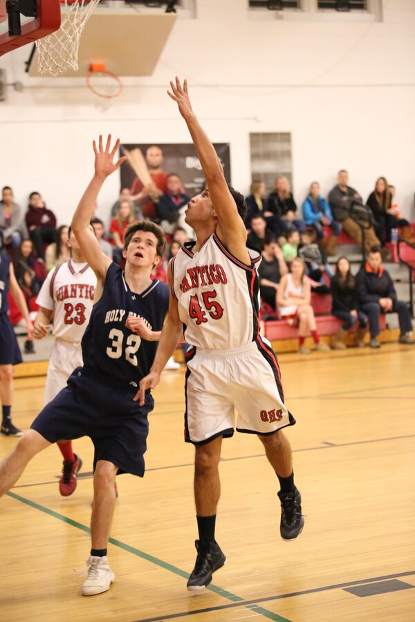 Elijah attempts to score during the last home game of the season at the Quantico Middle/High School on Feb. 11, 2014. The Warriors beat the Holy Family Academy Vendeens, from Manassas, 77-65 after honoring the senior cheerleaders and athletes in a pregame ceremony. 