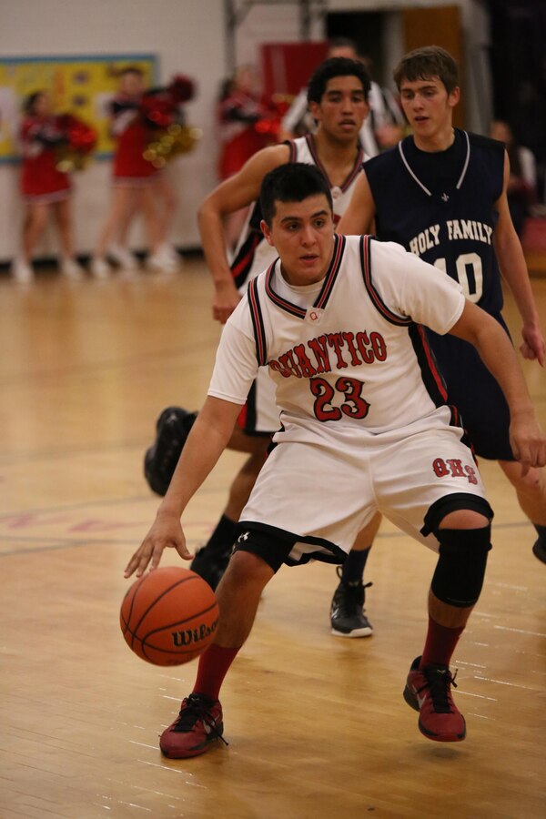 Anthony, senior, dribbles a ball during the last home game of the season at the Quantico Middle/High School on Feb. 11, 2014. Anthony and two other seniors participated in winning the game against Holy Family Academy, from Manassas, on senior night, 77-65. 