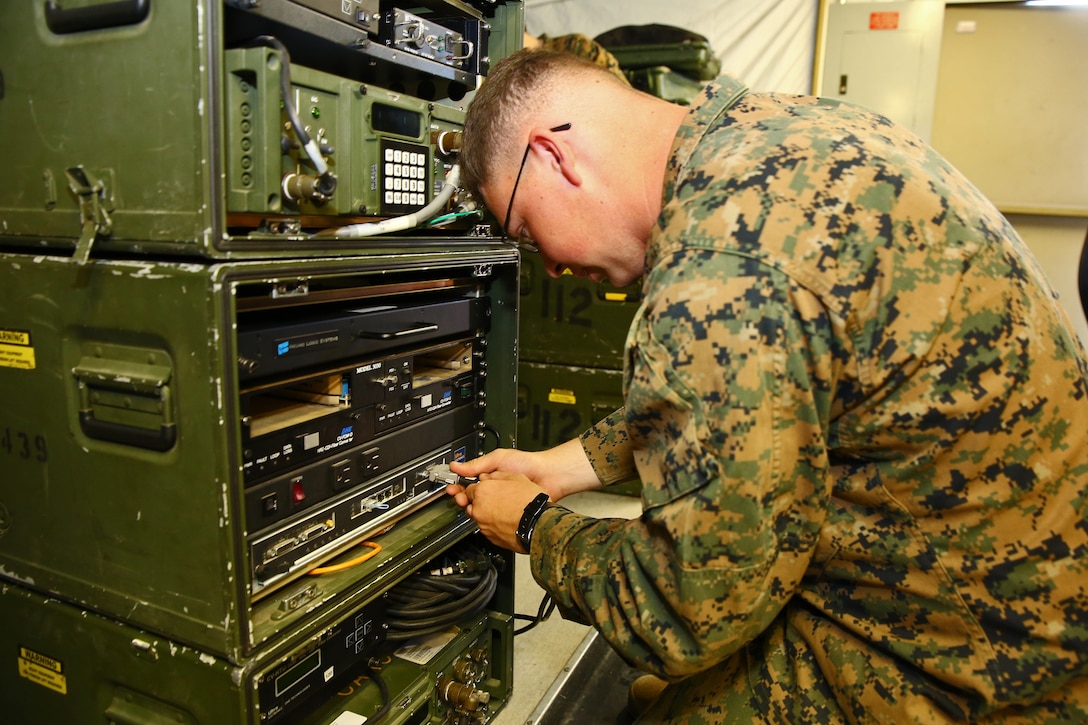 Private 1st Class Kyle J. Morrison, digital wideband transmission equipment operator, Communications Company, Combat Logistics Regiment 17, 1st Marine Logistics Group, sets up an AN/MRC-142 Digital Wideband Transmission System during a two-week line training exercise aboard Camp Pendleton, Calif., Feb. 12, 2014. The training is a series of hands-on instruction on communications systems to prepare the unit for the upcoming Combat Operations Center exercise. Morrison, 21, is from Houma, La. 