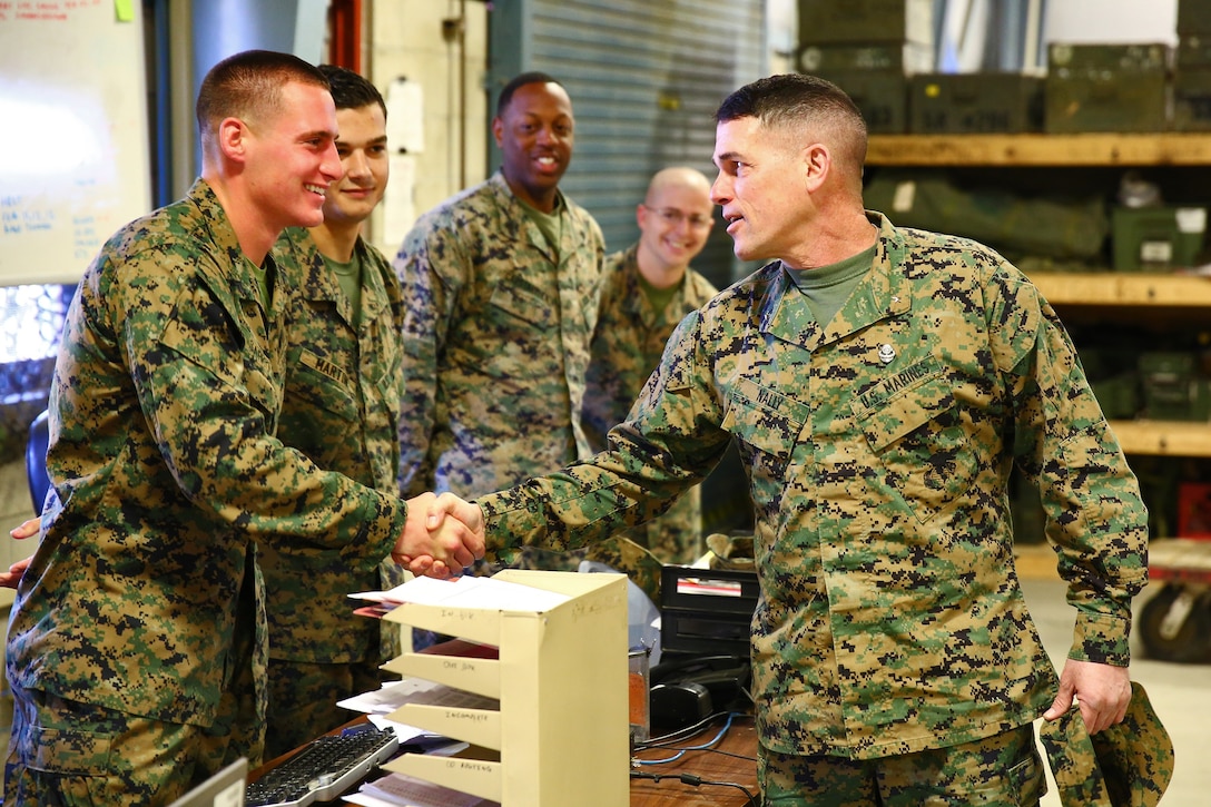 Brigadier General Kevin J. Nally, director, Command, Control, Communications and Computers, shakes hands with Cpl. Lucas G. Sarko, radio operator, Communications 
Company, Combat Logistics Regiment 17, 1st Marine Logistics Group. Gen. Nally toured the company aboard Camp Pendleton, Calif., Feb. 11, 2014. During the visit, Marines from 1st MLG conducted line training, a series of hands-on instruction on communications systems in preparation for the unit’s upcoming Combat Operations Center exercise.