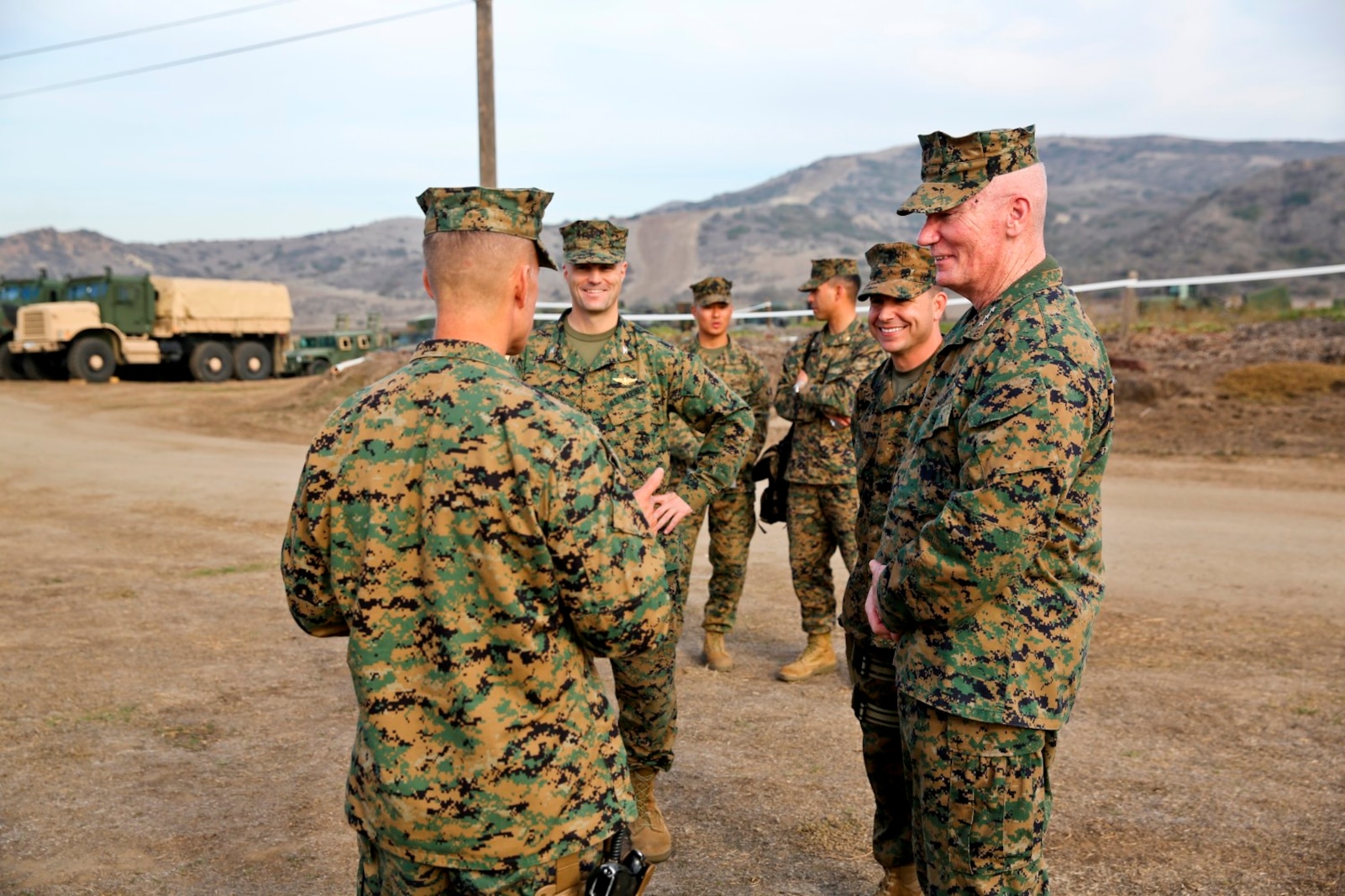 Brig. Gen. Carl E. Mundy, commanding general of 1st Marine Expeditionary Brigade, greets Lt. Gen. John A. Toolan, commanding general of I Marine Expeditionary Force, at the gate of a MEB command post during an exercise aboard Camp Pendleton, Calif., Feb. 11. Toolan toured the command operations center and other elements of the Brigade Headquarters Group supporting the needs of the MEB.