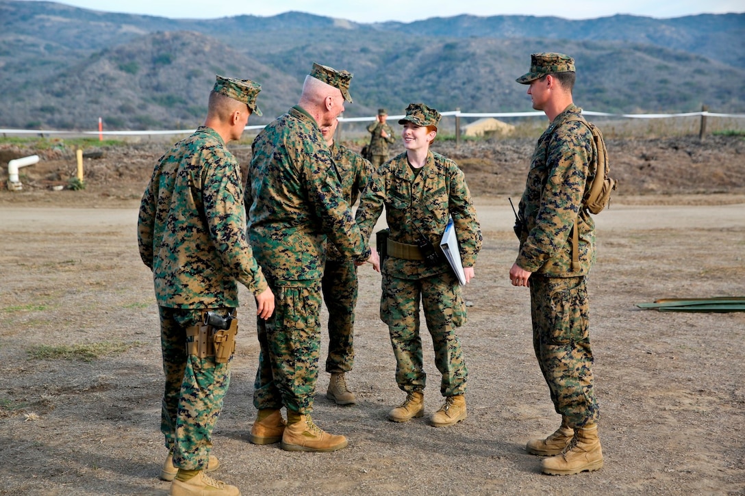 Lt. Gen. John A. Toolan, commanding general of I Marine Expeditionary Force, shakes hands with Marines during the 1st Marine Expeditionary Brigade command post exercise aboard Camp Pendleton, Calif., Feb. 11. Toolan toured the command operations center and other elements of the Brigade Headquarters Group supporting the needs of the MEB.