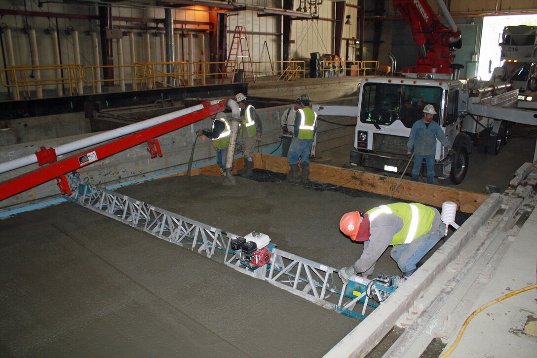 The large FERF facility at CRREL can simulate cold weather conditions on full-scale systems (here is a full-scale concrete test section emplacement) to reliably predict performance under frost conditions.