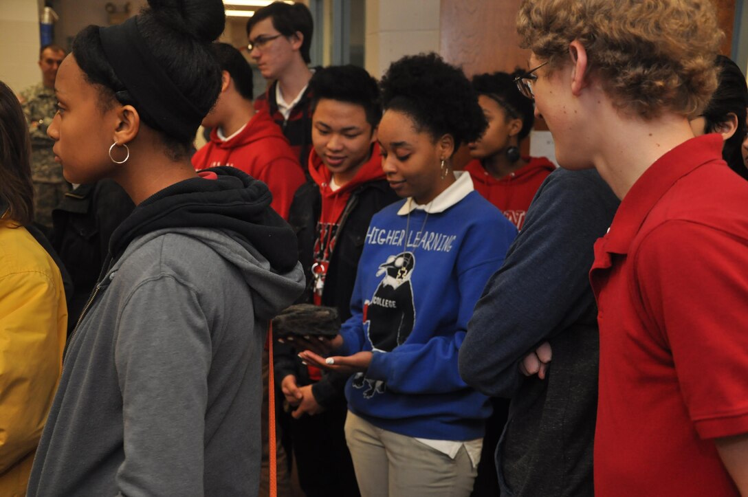 Jenkins High School students pass around a rock while learning about geology during a visit by the U.S. Army Corps of Engineers, Feb. 13, 2014. The visit aimed to recruit students to pursue science and engineering related career paths as part of National Engineers Week.