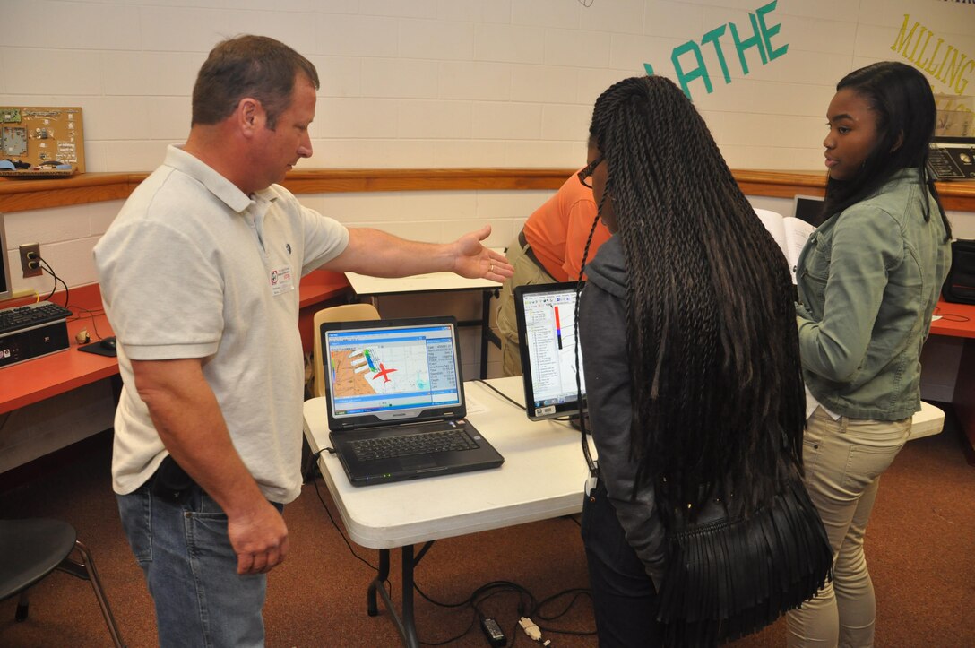 Mike Ansley, a member of the survey team for the U.S. Army Corps of Engineers Savannah District, explains how the Corps uses computer equipment to survey land during a visit to Jenkins High School, Feb. 13, 2014. The visit aimed to recruit students to pursue science and engineering related career paths as part of National Engineers Week.