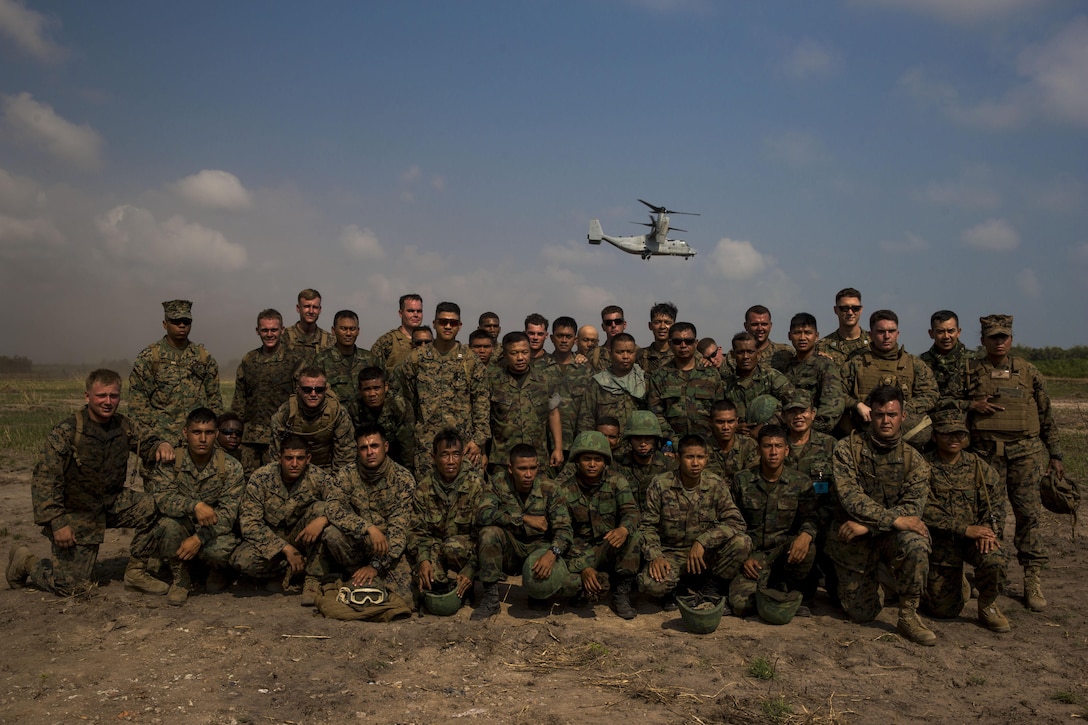 Royal Thai and U.S. Marines pose for a group photo at Utaphao, Kingdom of Thailand Feb. 17 during Exercise Cobra Gold 2014. Thai and U.S. relationship is strong and very important to both countries providing a solid foundation for continued regional peace and security. The U.S. Marines are Landing Support Specialists with Combat Logistics Battalion 4, Combat Logistics Regiment 3, 3rd Marine Logistics Group. The Royal Thai Marines are shore management with Landing Force Company, Support Regiment, Marine Corps Division.