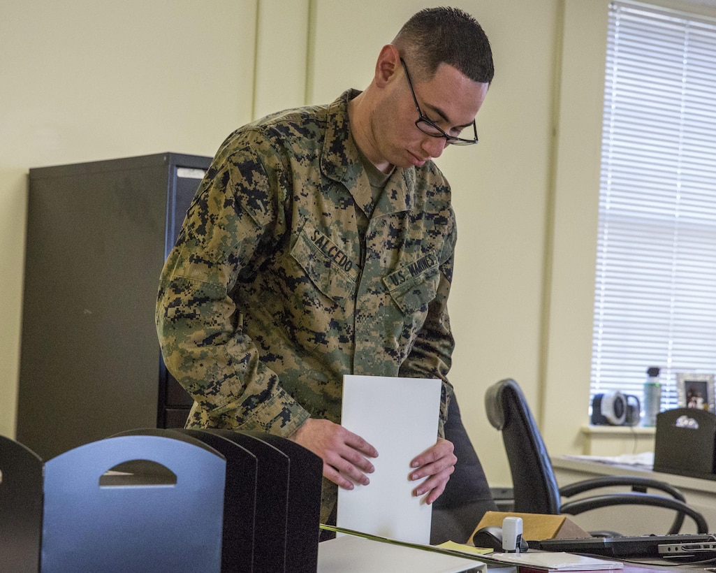 U.S. Marine Corps Cpl. Roberto A. Salcedo, an administrative specialist with the 26th Marine Expeditionary Unit (MEU) and a Los Angeles native, at work in the 26th MEU command post Dec. 16, 2013, aboard Marine Corps Base Camp Lejeune, N.C. Salcedo deployed for eight months with the MEU during its deployment to the 5th and 6th Fleet areas of responsibility from March 5, 2013 to November 7, 2013. (U.S. Marine Corps photo by Lance Cpl. Joshua W. Brown/released)