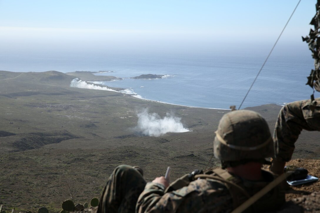 U.S. Marines from 1st Air Naval Gunfire Liaison Company and soldiers with the Japan Ground Self-Defense Force call for fire during Exercise Iron Fist 2014 aboard San Clemente Island, Calif., Feb. 13, 2014. Iron Fist 2014 is an amphibious exercise that brings together Marines and sailors from the 15th Marine Expeditionary Unit, other I Marine Expeditionary Force units, and soldiers from the JGSDF, to promote military interoperability and hone individual and small-unit skills through challenging, complex and realistic training. (U.S. Marine Corps photo by Lance Cpl. Anna K. Albrecht/Released)