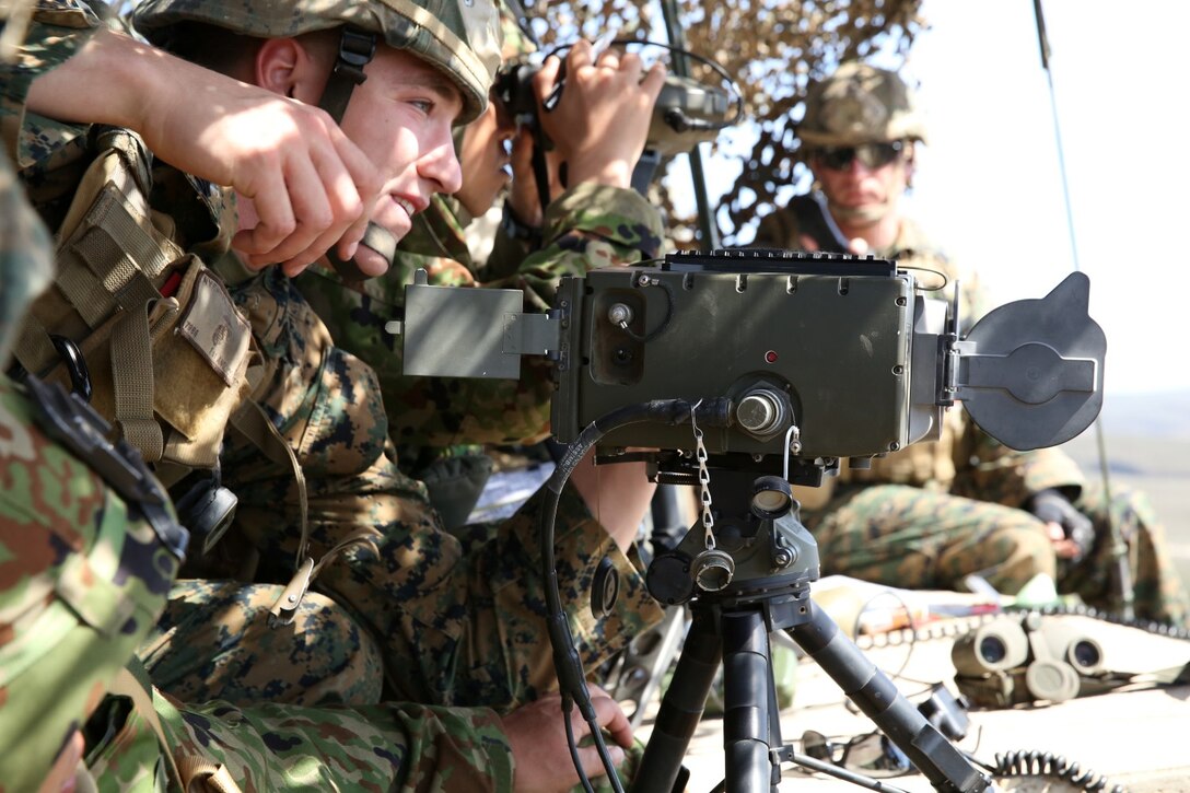 U.S. Marine Cpl. Luke Nyenhuis, fire support man, 1st Air Naval Gunfire Liaison Company, plots targets with soldiers from the Japan Ground Self-Defense Force during Exercise Iron Fist 2014 aboard San Clemente Island, Calif., Feb. 13, 2014. Iron Fist 2014 is an amphibious exercise that brings together Marines and sailors from the 15th Marine Expeditionary Unit, other I Marine Expeditionary Force units, and soldiers from the JGSDF, to promote military interoperability and hone individual and small-unit skills through challenging, complex and realistic training. (U.S. Marine Corps photo by Lance Cpl. Anna K. Albrecht/Released)