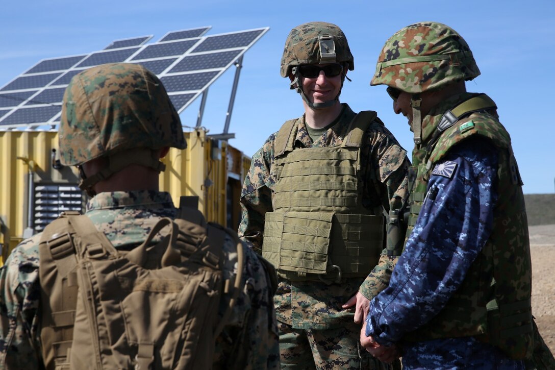 U.S. Marine Maj. Paul Bartok, middle, Marine liaison to the Western Army Infantry Regiment, Japan Ground Self-Defense Force, speaks with officials of the JGSDF during Exercise Iron Fist 2014 aboard San Clemente Island, Calif., Feb. 13, 2014. Iron Fist is an amphibious exercise that brings together Marines and sailors from the 15th Marine Expeditionary Unit, other I Marine Expeditionary Force units, and soldiers from the JGSDF, to promote military interoperability and hone individual and small-unit skills through challenging, complex and realistic training. (U.S. Marine Corps photo by Lance Cpl. Ricardo Hurtado/Released)
