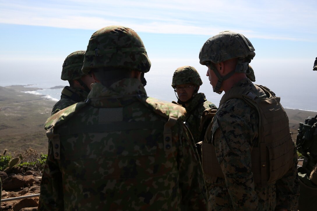 U.S. Marine Maj. Bryan Hall, right, commander, 1st Brigade Platoon, 1st Air Naval Gunfire Liaison Company, speaks with officials of the Japan Ground Self-Defense Force during Exercise Iron Fist 2014 aboard San Clemente Island, Calif., Feb. 13, 2014. Iron Fist is an amphibious exercise that brings together Marines and sailors from the 15th Marine Expeditionary Unit, other I Marine Expeditionary Force units, and soldiers from the JGSDF, to promote military interoperability and hone individual and small-unit skills through challenging, complex and realistic training. (U.S. Marine Corps photo by Lance Cpl. Ricardo Hurtado/Released)