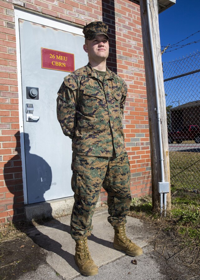 U.S. Marine Corps Cpl. Hansen, a chemical, biological, radiological and nuclear defense (CBRN) specialist with the 26th Marine Expeditionary Unit (MEU) and Cumming, Ga., native, poses for a photo outside the 26th MEU CBRN warehouse aboard Marine Corps Base Camp Lejeune, N.C., Dec. 19, 2013. Hansen deployed with the MEU during its last eight-month deployment to the 5th and 6th Fleet areas of responsibility in 2013. (U.S. Marine Corps photo by Lance Cpl. Joshua W. Brown/released)