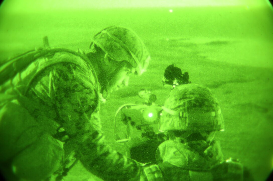 U.S. Marine Cpl. Shawn Brakey, left, fire support man, 1st Air Naval Gunfire Liaison Company assists a soldier with the Japan Ground Self-Defense Force during Exercise Iron Fist 2014 aboard San Clemente Island, Calif., Feb. 13, 2014. Iron Fist 2014 is an amphibious exercise that brings together Marines and sailors from the 15th Marine Expeditionary Unit, other I Marine Expeditionary Force units, and soldiers from the JGSDF, to promote military interoperability and hone individual and small-unit skills through challenging, complex and realistic training. (U.S. Marine Corps photo by Lance Cpl. Anna K. Albrecht/Released)