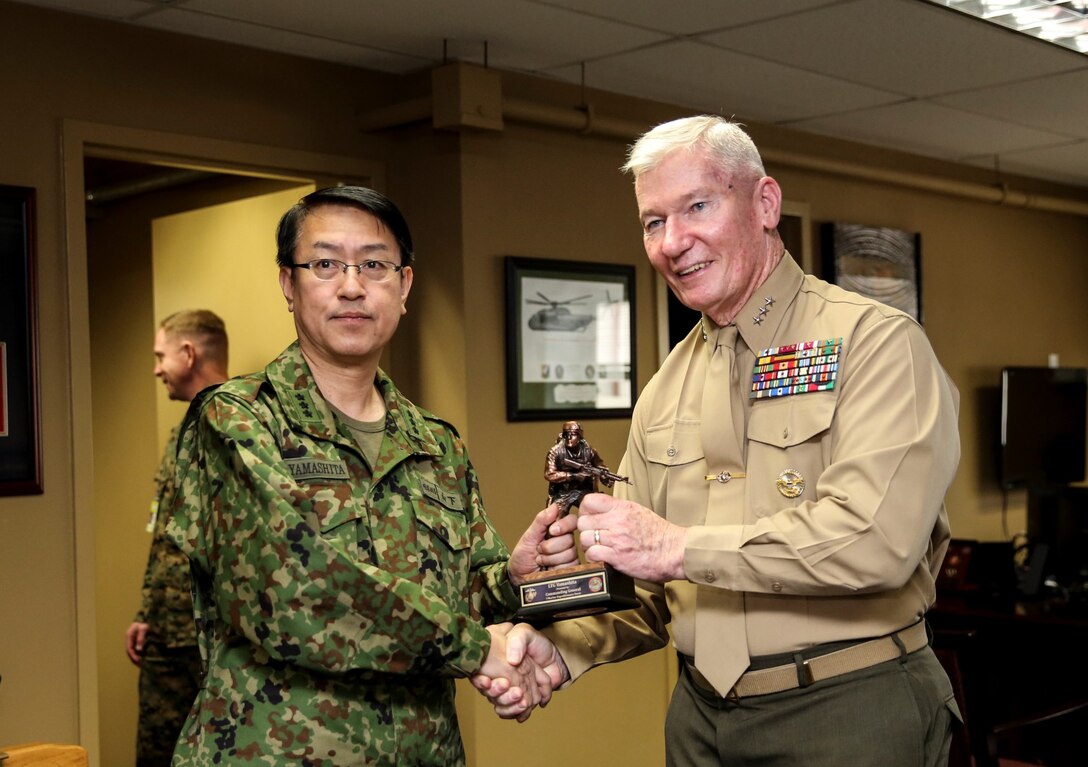 U.S. Marine Lt. Gen. John A. Toolan, right, commanding general, I Marine Expeditionary Force, presents Lt. Gen. Hirotaka Yamashita, vice chief of staff, Japan Ground Self-Defense Force, with a statue of a Marine during Exercise Iron Fist 2014 aboard Camp Pendleton, Calif., Feb. 14. Iron Fist is an amphibious exercise that brings together Marines and sailors from the 15th Marine Expeditionary Unit, other I Marine Expeditionary Force units, and soldiers from the JGSDF, to promote military interoperability and hone individual and small-unit skills through challenging, complex and realistic training. (U.S. Marine Corps photo by Cpl. Emmanuel Ramos/Released)
