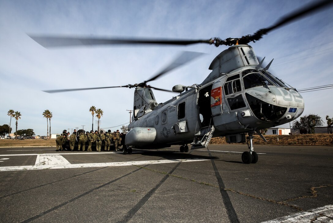 Soldiers from the Japan Ground Self-Defense Force load a combat rubber reconnaissance craft into a CH-46E Sea Knight while conducting helocast training with 1st Reconnaissance Battalion, 1st Marine Division, during Exercise Iron Fist 2014 aboard Camp Pendleton, Calif., Feb. 15, 2014. Iron Fist is an amphibious exercise that brings together Marines and sailors from the 15th Marine Expeditionary Unit, other I Marine Expeditionary Force units, and soldiers from the JGSDF, to promote military interoperability and hone individual and small-unit skills through challenging, complex and realistic training. (U.S. Marine Corps photo by Cpl. Emmanuel Ramos/Released)