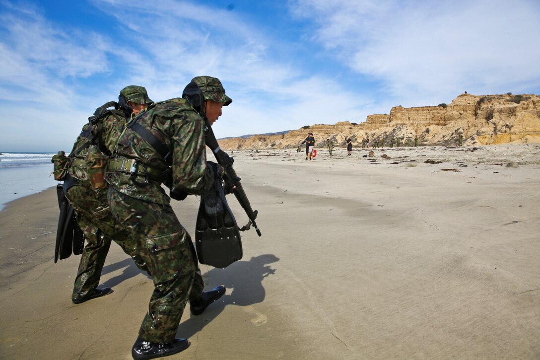 Soldiers from the Japan Ground Self-Defense Force secure a beach while conducting an amphibious raid during Exercise Iron Fist 2014 aboard Camp Pendleton, Calif., Feb. 15, 2014. Iron Fist is an amphibious exercise that brings together Marines and sailors from the 15th Marine Expeditionary Unit, other I Marine Expeditionary Force units, and soldiers from the JGSDF, to promote military interoperability and hone individual and small-unit skills through challenging, complex and realistic training. (U.S. Marine Corps photo by Lance Cpl. Ricardo Hurtado/Released)