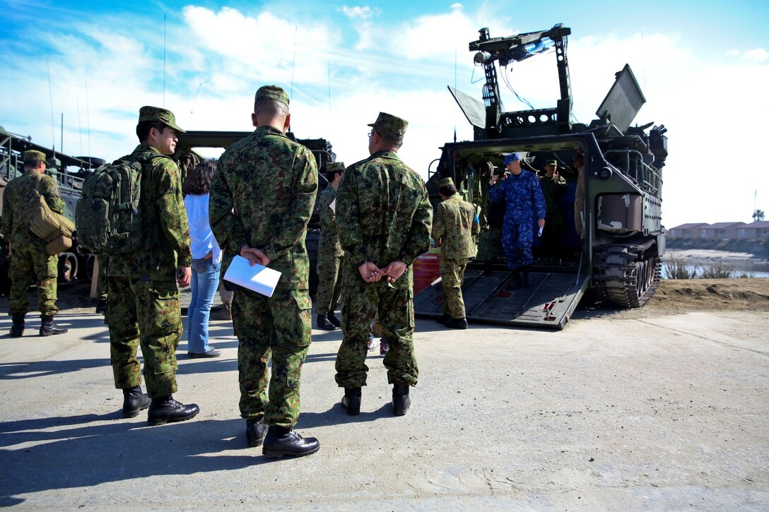 Officials from the Japan Ground Self-Defense Force observe and learn about AAV-7 Assault Amphibious Vehicles during Exercise Iron Fist 2014 aboard Camp Pendleton, Calif., Feb. 16, 2014. Iron Fist is an amphibious exercise that brings together Marines and sailors from the 15th Marine Expeditionary Unit, other I Marine Expeditionary Force units, and soldiers from the JGSDF, to promote military interoperability and hone individual and small-unit skills through challenging, complex and realistic training. (U.S. Marine Corps photo by Lance Cpl. Ricardo Hurtado/Released)