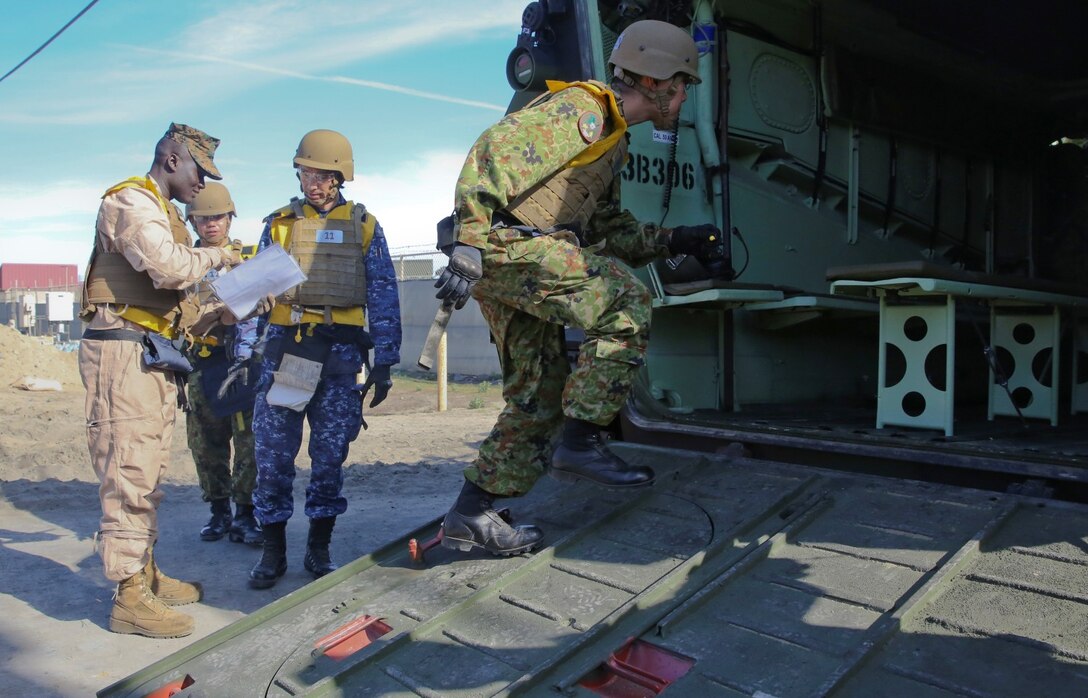 Officials from the Japan Ground Self-Defense Force go aboard an AAV-7 Assault Amphibious Vehicle during Exercise Iron Fist 2014 aboard Camp Pendleton, Calif., Feb. 16, 2014. Iron Fist is an amphibious exercise that brings together Marines and sailors from the 15th Marine Expeditionary Unit, other I Marine Expeditionary Force units, and soldiers from the JGSDF, to promote military interoperability and hone individual and small-unit skills through challenging, complex and realistic training. (U.S. Marine Corps photo by Lance Cpl. Ricardo Hurtado/Released)