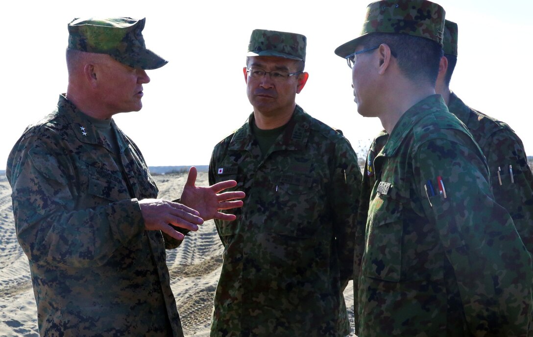 U.S. Marine Maj. Gen. Lawrence Nicholson, left, commanding general, 1st Marine Division, speaks with officials from the Japan Ground Self-Defense Force after a splash demonstration with AAV-7 Assault Amphibious Vehicles during Exercise Iron Fist 2014 aboard Camp Pendleton, Calif., Feb. 16, 2014. Iron Fist is an amphibious exercise that brings together Marines and sailors from the 15th Marine Expeditionary Unit, other I Marine Expeditionary Force units, and soldiers from the JGSDF, to promote military interoperability and hone individual and small-unit skills through challenging, complex and realistic training. (U.S. Marine Corps photo by Lance Cpl. Ricardo Hurtado/Released)