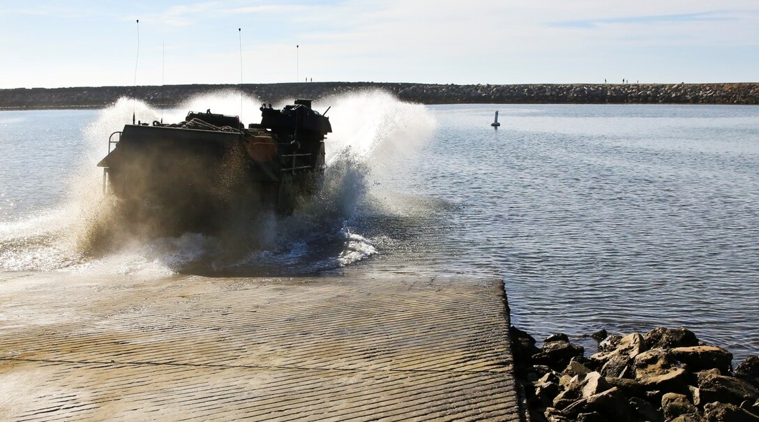 An AAV-7 Assault Amphibious Vehicle goes into the water while conducting a splash demonstration during Exercise Iron Fist 2014 aboard Camp Pendleton, Calif., Feb. 16, 2014. Iron Fist is an amphibious exercise that brings together Marines and sailors from the 15th Marine Expeditionary Unit, other I Marine Expeditionary Force units, and soldiers from the JGSDF, to promote military interoperability and hone individual and small-unit skills through challenging, complex and realistic training. (U.S. Marine Corps photo by Lance Cpl. Ricardo Hurtado/Released)