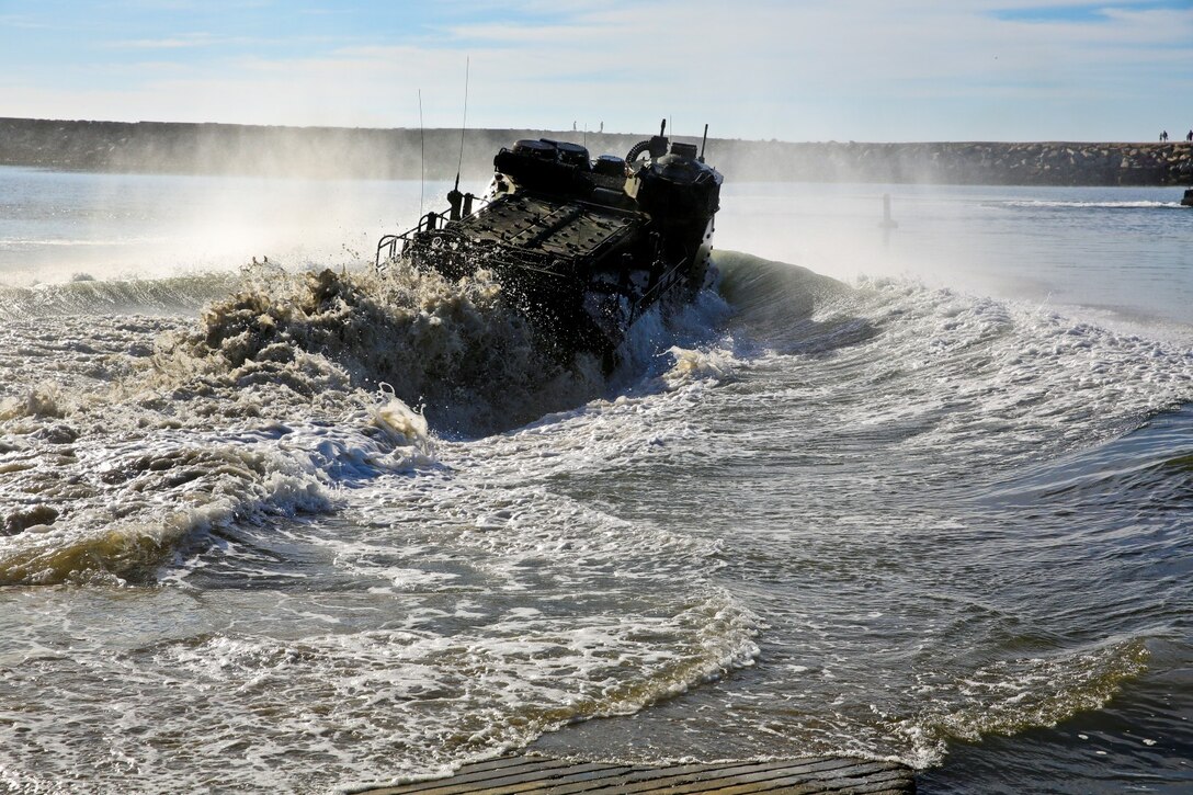 An AAV-7 Assault Amphibious Vehicle goes into the water while conducting a splash demonstration during Exercise Iron Fist 2014 aboard Camp Pendleton, Calif., Feb. 16, 2014. Iron Fist is an amphibious exercise that brings together Marines and sailors from the 15th Marine Expeditionary Unit, other I Marine Expeditionary Force units, and soldiers from the JGSDF, to promote military interoperability and hone individual and small-unit skills through challenging, complex and realistic training. (U.S. Marine Corps photo by Lance Cpl. Ricardo Hurtado/Released)