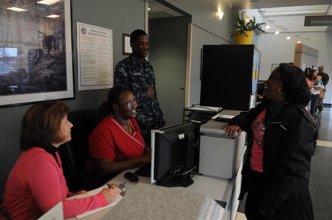 From left, medical support assistants Ruthie Duvall and LaQwada Washington and Seaman Jakeitheon Wilson chat with patient Myrtle Smyre-Lightfoot as she checks in with the new “Green Team” on Feb. 5, the second day of its existence. 