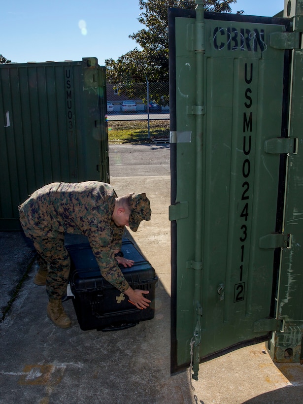 U.S. Marine Corps Cpl. Jacob Hansen, a chemical, biological, radiological and nuclear defense (CBRN) specialist with the 26th Marine Expeditionary Unit (MEU)  and Cumming, Ga., native, unloads a CBRN storage unit outside the 26th MEU CBRN warehouse aboard Marine Corps Base Camp Lejeune, N.C., Dec. 19, 2013. Hansen was promoted to the rank of corporal while deployed with the MEU during it's last eight-month deployment to the 5th and 6th Fleet areas of responsibility. (U.S. Marine Corps photo by Lance Cpl. Joshua W. Brown/released)