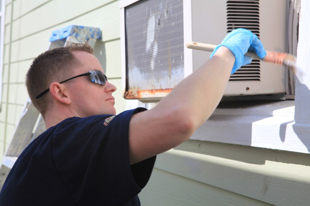 ALGIERS, La. – Petty Officer 2nd Class William Wesley, a navy aviation support equipment technician with the Fleet Readiness Center Mid-Atlantic Site New Orleans, paints a window frame on a house being renovated by the NBA Cares outreach initiative, Feb. 14, 2014. NBA Cares, a community outreach initiative that focuses on community development, education and health, hosted an All-Star Day of Service that was staffed by volunteers from local areas, visitors from across the country and service members from all five branches of the U.S. military, as well as current and former NBA athletes. (U.S. Marine Corps photo by Cpl. Tiffany Edwards)